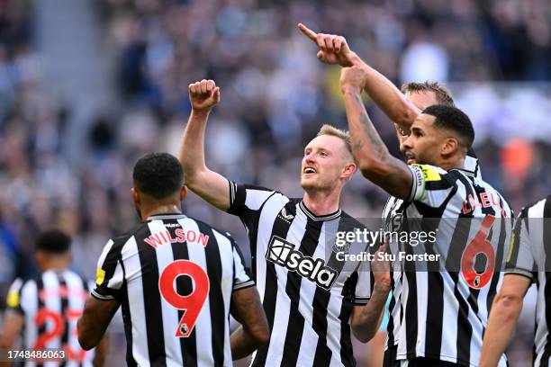 Sean Longstaff of Newcastle United celebrates after scoring the team's third goal with teammates during the Premier League match between Newcastle...