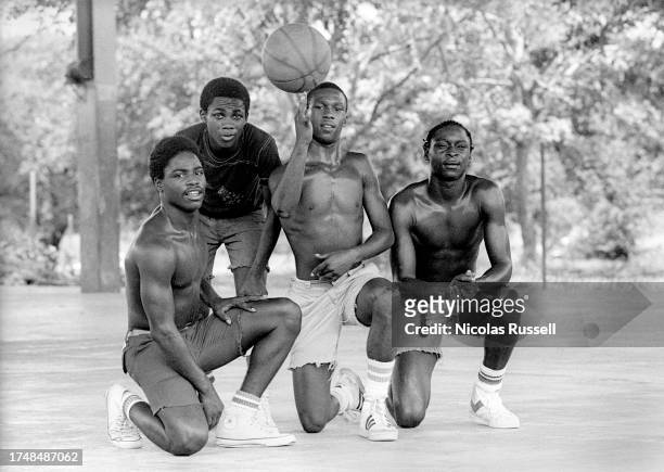 Photograph of four African American teens after playing basketball in 1983 in Houston, Texas.