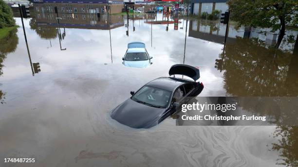 In this aerial view flooded cars are abandoned in the Pentagon area of Derby after the River Derwent burst its banks during storm Babet on October...