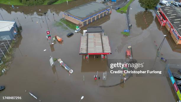 In this aerial view a petrol station is flooded in the Pentagon area of Derby after the River Derwent burst its banks during storm Babet on October...