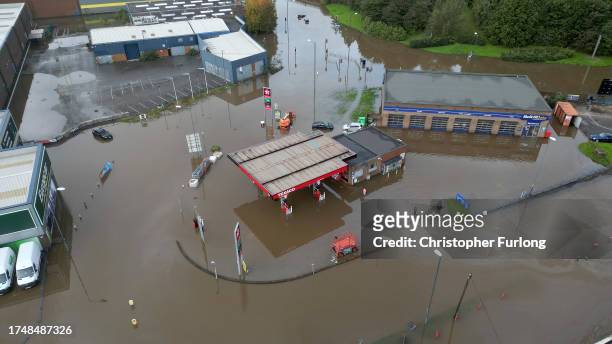 In this aerial view a petrol station is flooded in the Pentagon area of Derby after the River Derwent burst its banks during storm Babet on October...