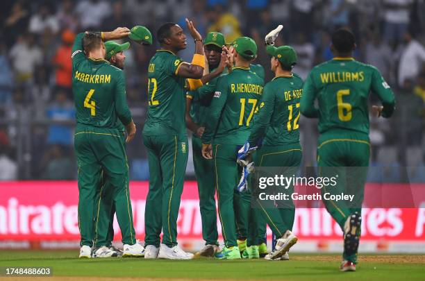 Lungi Ngidi of South Africa celebrates with team mates after dismissing David Willey of England during the ICC Men's Cricket World Cup India 2023...