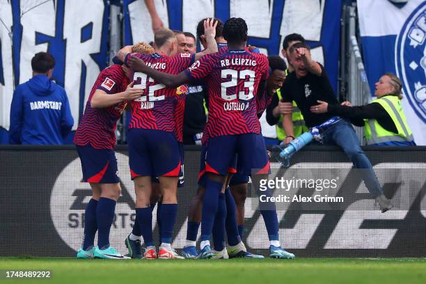 Lois Openda of RB Leipzig celebrates with teammates after scoring the team's third goal during the Bundesliga match between SV Darmstadt 98 and RB...