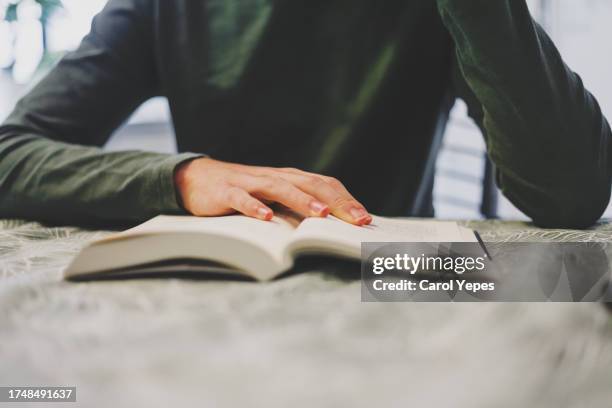 medium shot of unrecognizable person reading a book - relax brain bildbanksfoton och bilder