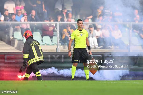 Flare is put out on the pitch by a firefighter during the Serie A TIM match between Hellas Verona FC and SSC Napoli at Stadio Marcantonio Bentegodi...