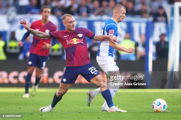 David Raum of RB Leipzig battles for possession with Tim Skarke of SV Darmstadt 98 during the Bundesliga match between SV Darmstadt 98 and RB Leipzig...