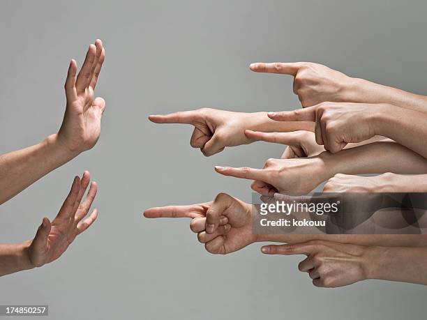grupo de las manos con el dedo apuntando - culpabilidad fotografías e imágenes de stock