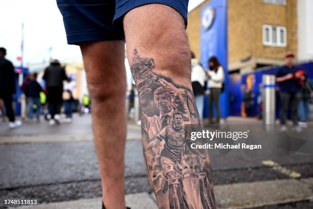 Detailed view of a Arsene Wenger and Aaron Ramsey tattoo is seen on a fan outside the stadum prior to the Premier League match between Chelsea FC and...