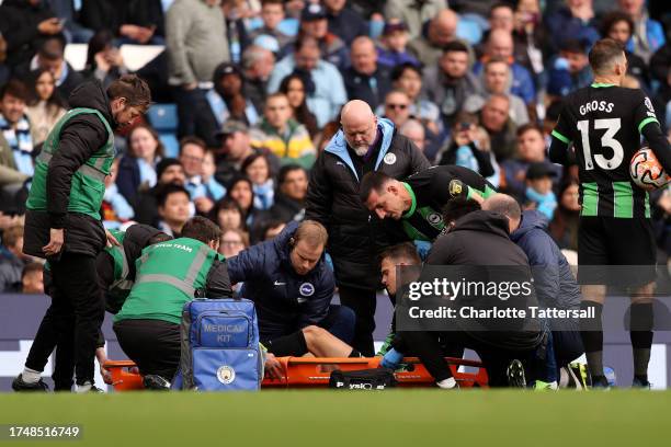 Solly March of Brighton & Hove Albion leaves the field on a stretcher after receiving medical treatment during the Premier League match between...