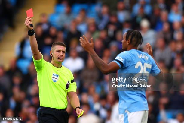 Manuel Akanji of Manchester City receives a red card from Referee Rob Jones during the Premier League match between Manchester City and Brighton &...