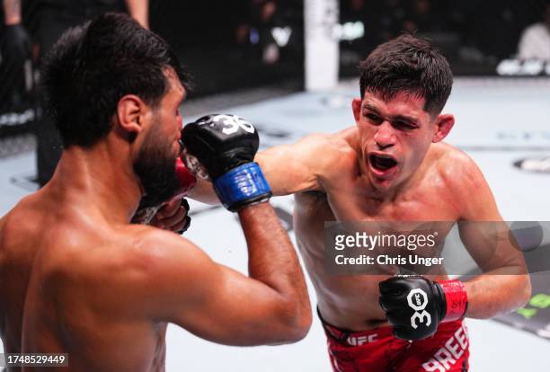 Mike Breeden punches Anshul Jubli of India in a lightweight fight during the UFC 294 event at Etihad Arena on October 21, 2023 in Abu Dhabi, United...