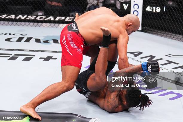 Abu Azaitar of Germany punches Sedriques Dumas in a middleweight fight during the UFC 294 event at Etihad Arena on October 21, 2023 in Abu Dhabi,...