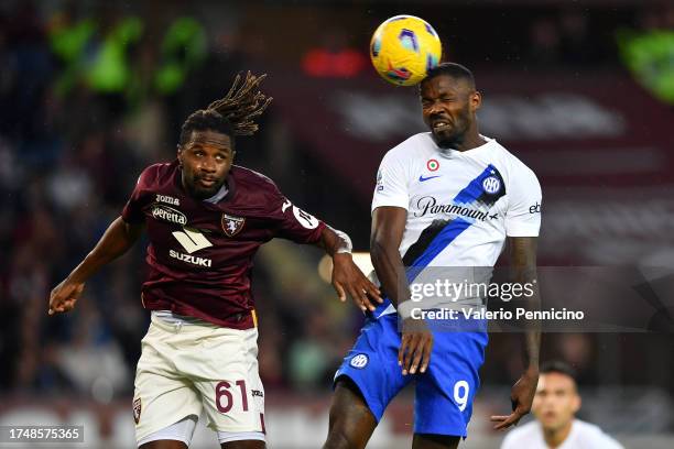 Adrien Tameze of Torino FC jumps for the ball with Marcus Thuram of FC Internazionale during the Serie A TIM match between Torino FC and FC...