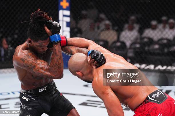 Abu Azaitar of Germany punches Sedriques Dumas in a middleweight fight during the UFC 294 event at Etihad Arena on October 21, 2023 in Abu Dhabi,...