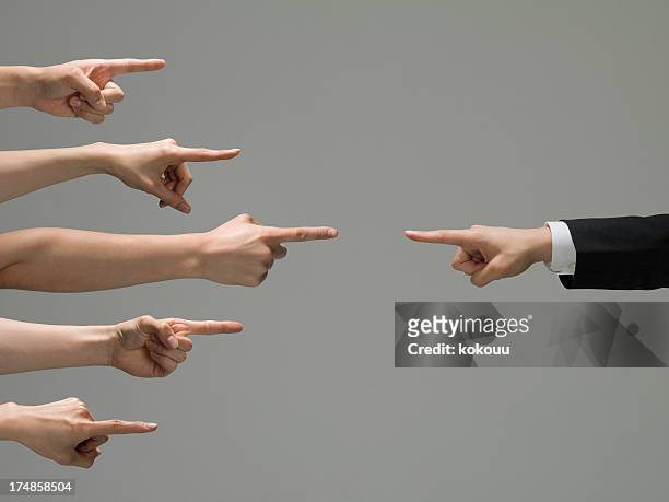 people who point at a businessman - rivaliteit stockfoto's en -beelden