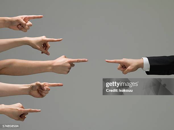 people who point at a businessman - konkurrens bildbanksfoton och bilder