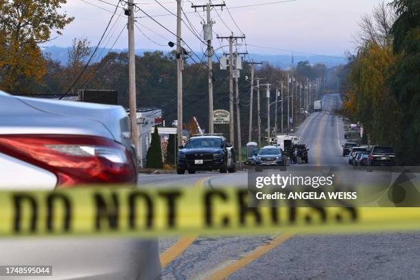 Police tape blocks off the street near Schemengees Bar and Grille in Lewiston, Maine, on October 27 in the aftermath of a mass shooting. Hundreds of...
