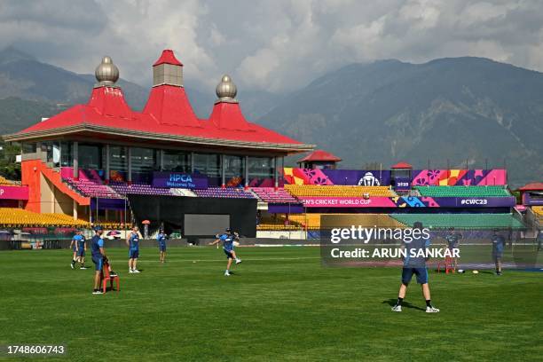 New Zealand's players attend a practice session on the eve of their 2023 ICC Men's Cricket World Cup one-day international match against Australia at...