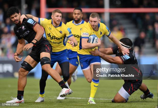 Finn Russell of Bath Rugby with the ball gets past Mako Vunipola of Saracens during the Gallagher Premiership Rugby match between Saracens and Bath...