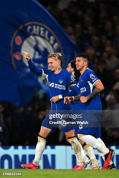 Mykhaylo Mudryk of Chelsea celebrates with teammate Enzo Fernandez after scoring the team's second goal during the Premier League match between...