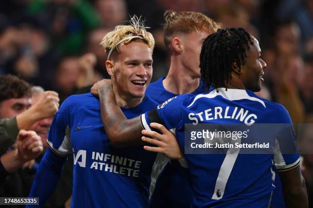 Mykhaylo Mudryk of Chelsea celebrates with teammates Cole Palmer and Raheem Sterling after scoring the team's second goal during the Premier League...