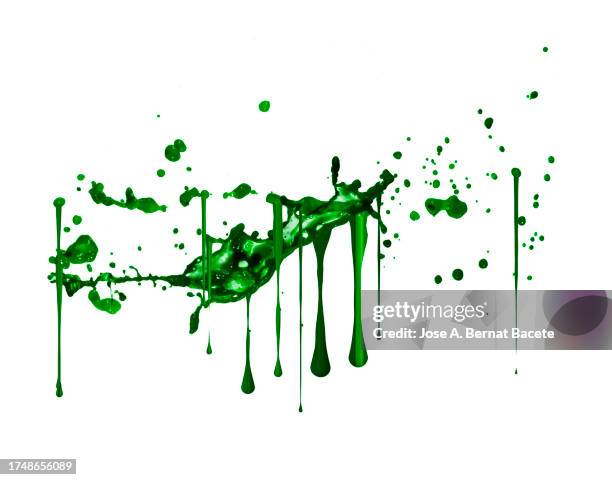 splashes and drops of green paint slide on a white wall. - green color ストックフォトと画像