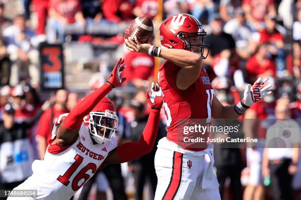 Brendan Sorsby of the Indiana Hoosiers throws a pass while rushed by Max Melton of the Rutgers Scarlet Knights during the first half at Memorial...