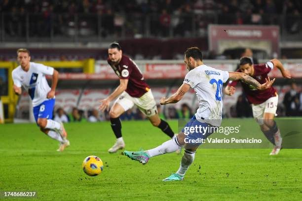 Hakan Calhanoglu of FC Internazionale scores the team's third goal from a penalty during the Serie A TIM match between Torino FC and FC...