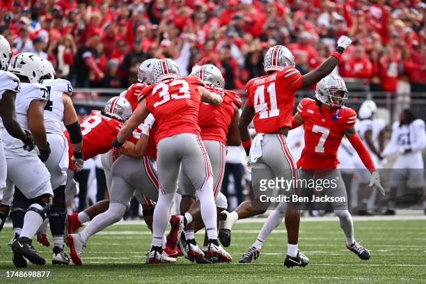 Josh Proctor of the Ohio State Buckeyes signals for fourth down after the Ohio State Buckeyes make a stop against the Penn State Nittany Lions in the...