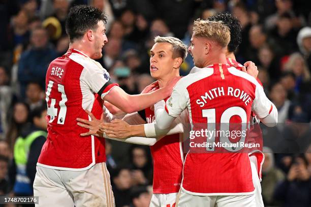 Leandro Trossard of Arsenal celebrates with teammates Declan Rice and Emile Smith Rowe after scoring the team's second goal during the Premier League...