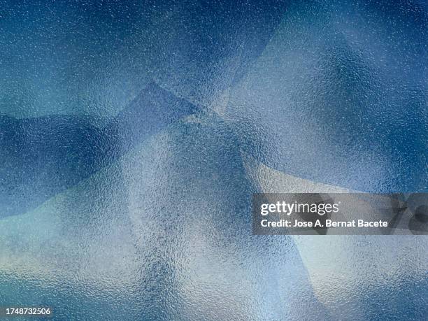abstract background, translucent frosted glass of blue color with cracks. - verre dépoli photos et images de collection