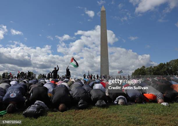 Pro-Palestinian protesters pray near the Washington Monument during a demonstration calling for a ceasefire in Gaza on October 21, 2023 in...