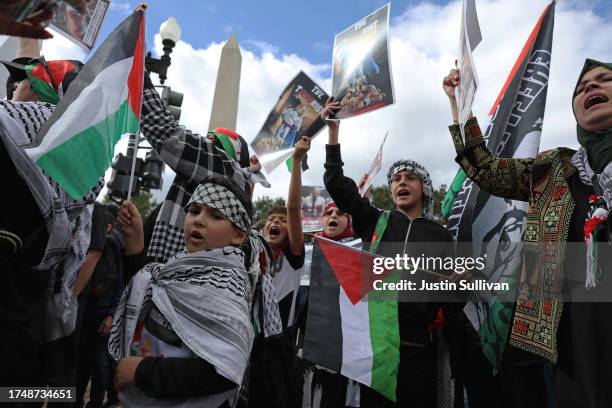 Pro-Palestinian protesters carry signs during a demonstration calling for a ceasefire in Gaza on October 21, 2023 in Washington, DC. Thousands of...