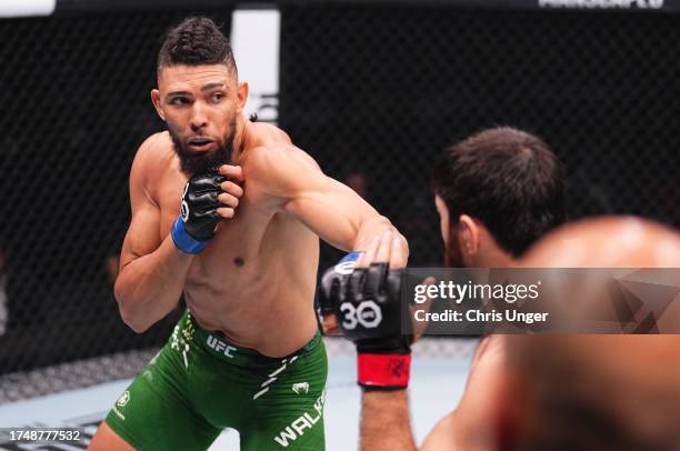 Johnny Walker of Brazil battles Magomed Ankalaev of Russia in a light heavyweight fight during the UFC 294 event at Etihad Arena on October 21, 2023...