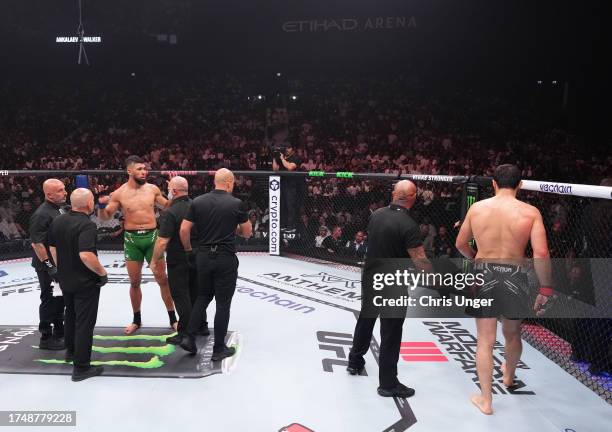 Johnny Walker of Brazil and Magomed Ankalaev of Russia react after the stoppage of their light heavyweight fight due to an unintentional foul during...