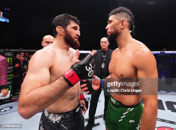 Johnny Walker of Brazil and Magomed Ankalaev of Russia react after the stoppage of their light heavyweight fight due to an unintentional foul during...