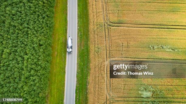 country road from above through agricultural fields - cement truck stock pictures, royalty-free photos & images
