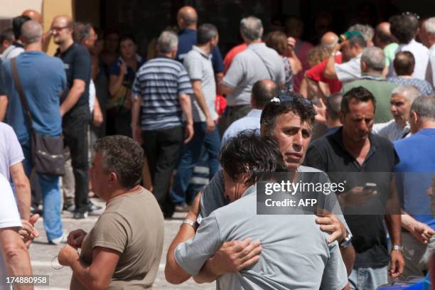 Friends and relatives of the victims of a bus crash on the road between Monteforte Irpino and Baiano react on July 29 near the morgue in Monteforte...