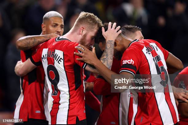 Oliver McBurnie of Sheffield United celebrates with teammates after scoring the team's first goal from the penalty spot during the Premier League...