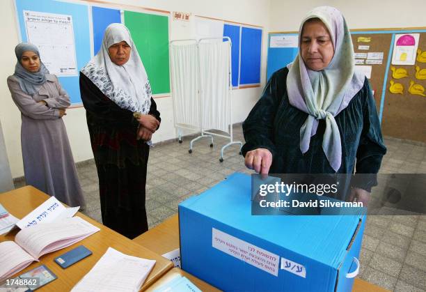 An Israeli Arab woman votes at a polling station in a school January 28, 2003 in the village of Jaljuliya, central Israel. Israeli Prime Minister...