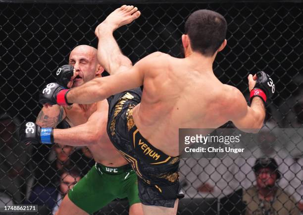 Islam Makhachev of Russia kicks Alexander Volkanovski of Australia in the UFC lightweight championship fight during the UFC 294 event at Etihad Arena...