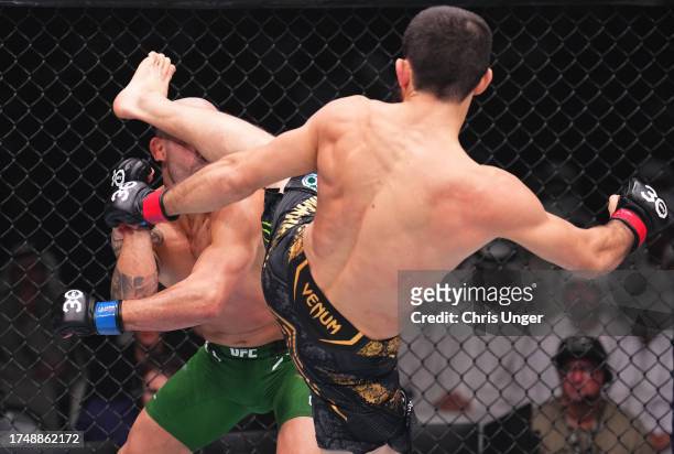 Islam Makhachev of Russia kicks Alexander Volkanovski of Australia in the UFC lightweight championship fight during the UFC 294 event at Etihad Arena...