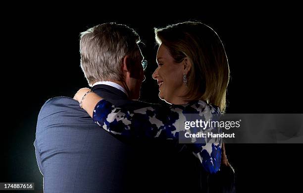 In this handout provided by the Chancellerie du Premier Ministre, Queen Mathilde of Belgium and King Philippe of Belgium appear on the the balcony of...