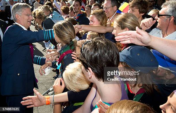 In this handout provided by the Chancellerie du Premier Ministre, King Philippe of Belgium greets the public as he attends the celebrations in the...