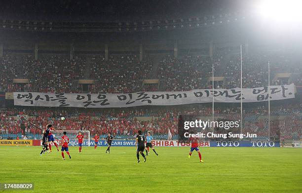 South Korean supporters show a banner 'A nation that forgets history has no future' during the EAFF East Asian Cup match between Korea Republic and...
