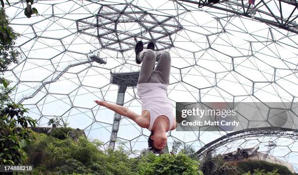 Tim Sheiff, professional freerunner and parkour expert somersaults inside the Eden Project's Rainforest Biome on July 29, 2013 in St Austell,...