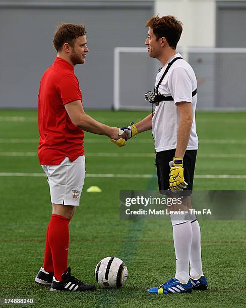 Olly Murs and Nick Grimshaw shake hands before the start of the BBC Radio 1 five-a-side football match between Team Grimshaw, captained by BBC Radio...