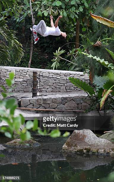 Pip Andersen professional freerunner and parkour expert somersaults inside the Eden's Rainforest Biome on July 29, 2013 in St Austell, England. Pip...