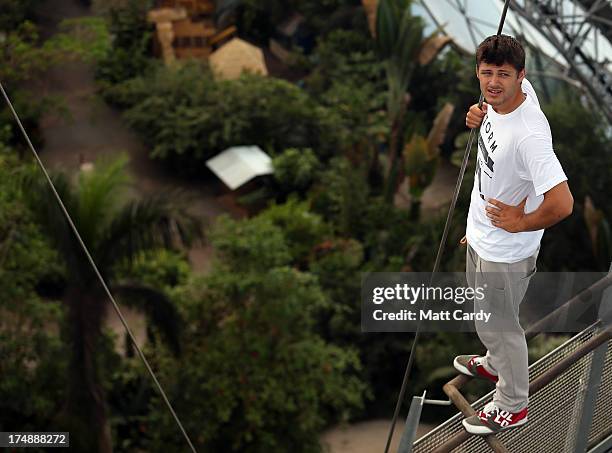 Pip Andersen professional freerunner and parkour expert stands on the edge of the railing to the viewing platform below the roof of the Eden's...