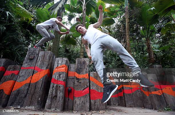 Pip Andersen and Tim Shieff, both professional freerunner and parkour experts, jump inside the Eden's Rainforest Biome on July 29, 2013 in St...